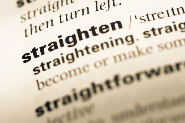 Close up of old English dictionary page with word straighten — Stock Photo, Image