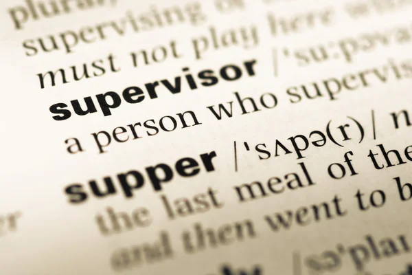 Close up of old English dictionary page with word supervisor — Stock Photo, Image