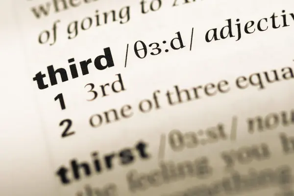 Fechar a página do dicionário de Inglês antigo com a palavra third — Fotografia de Stock
