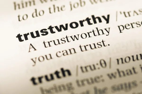 Close up of old English dictionary page with word trustworthy — Stock Photo, Image