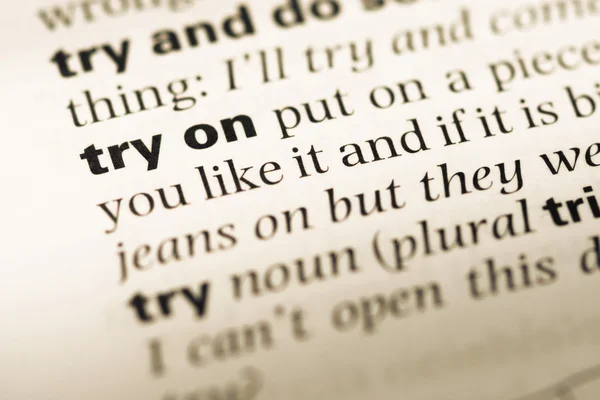 Close up of old English dictionary page with word try on — Stock Photo, Image