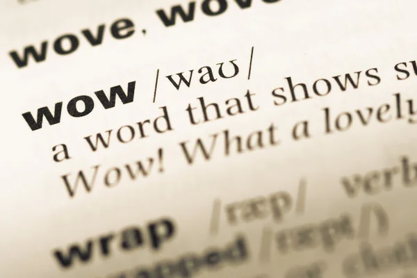 Close up of old English dictionary page with word wow — Stock Photo, Image