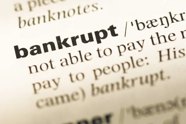 Nahaufnahme der alten englischen Wörterbuchseite mit dem Wort bankrott — Stockfoto