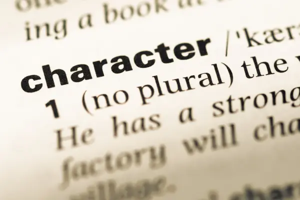 Close up of old English dictionary page with word character — Stock Photo, Image