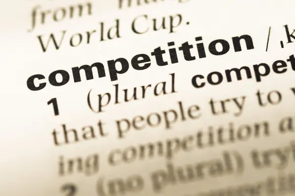 Close up of old English dictionary page with word competition — Stock Photo, Image