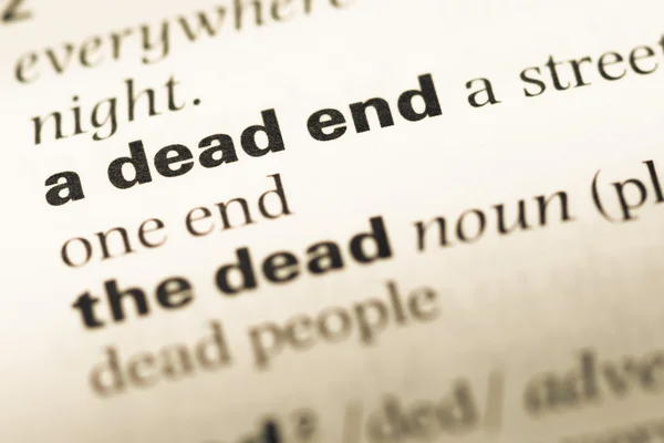 Close up of old English dictionary page with word a dead end — Stock Photo, Image