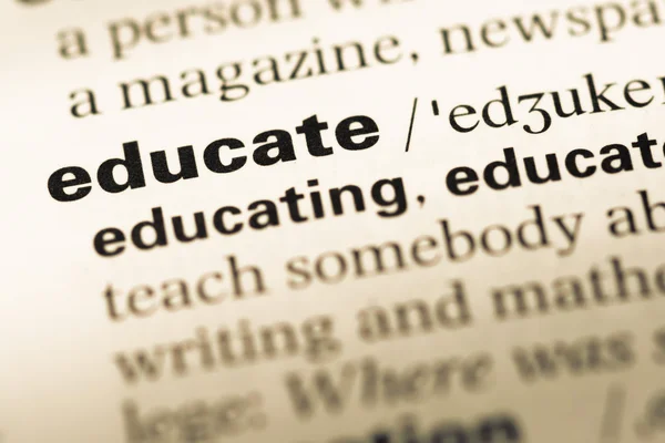 Close up of old English dictionary page with word educate — Stock Photo, Image