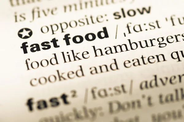 Close up of old English dictionary page with word fast food — Stock Photo, Image