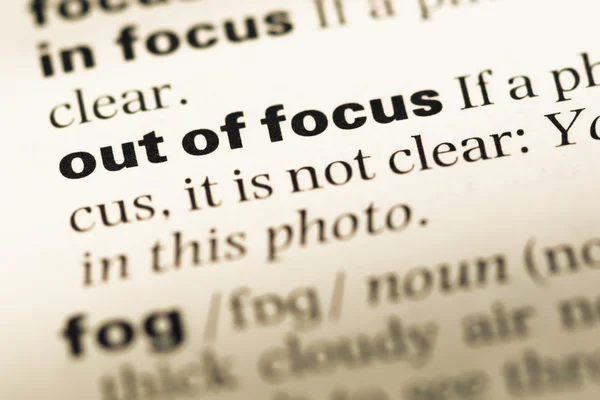 Close up of old English dictionary page with word out of focus — Stock Photo, Image