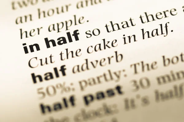 Close up of old English dictionary page with word in half — Stock Photo, Image