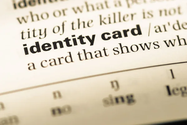 Close up of old English dictionary page with word identity card — Stock Photo, Image