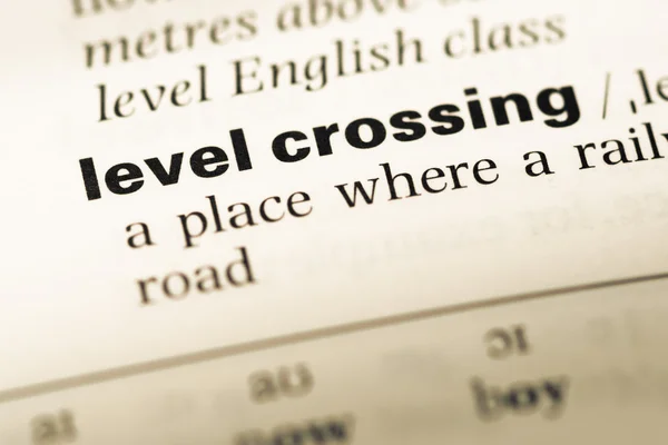 Close up of old English dictionary page with word level crossing — Stock Photo, Image