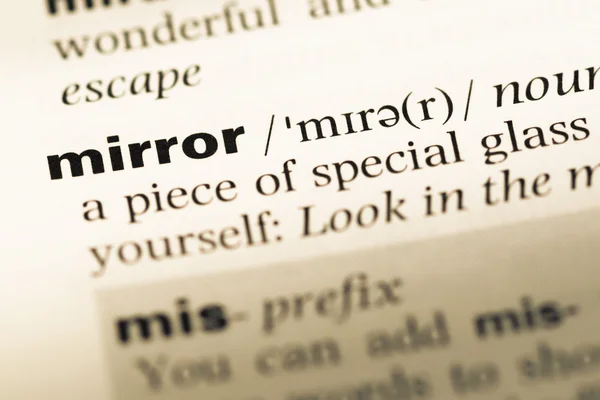 Close up of old English dictionary page with word mirror — Stock Photo, Image
