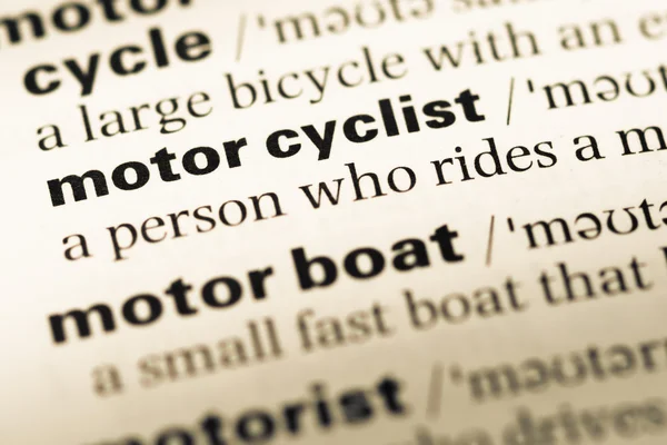 Close up of old English dictionary page with word motor cyclist — Stock Photo, Image