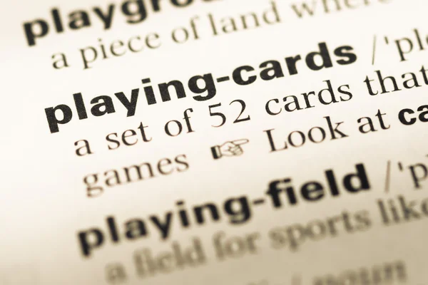 Close up of old English dictionary page with word playing card — Stock Photo, Image