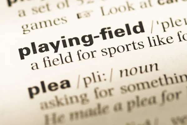 Close up of old English dictionary page with word playing field — Stock Photo, Image