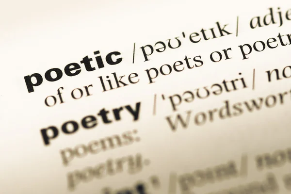 Close up of old English dictionary page with word poetic Royalty Free Stock Images