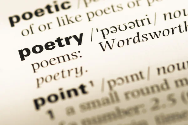 Close up of old English dictionary page with word poetry Stock Photo