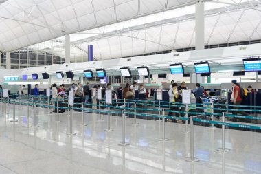 HONG KONG, CHINA - FEBRUARY 11: Passengers in the airport main lobby on February 11, 2013 in Hong Kong, China. The Hong Kong airport handles more than 70 million passengers per year.