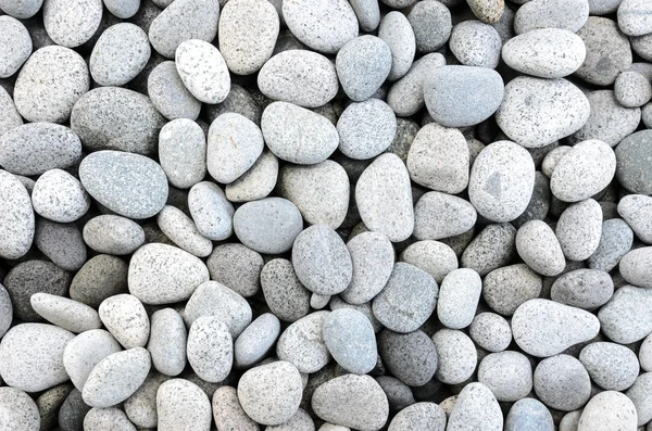 Naturally polished white rock pebbles background