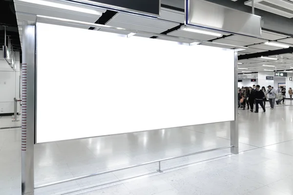 One big horizontal / landscape orientation blank billboard in public transport with blurred passenger background