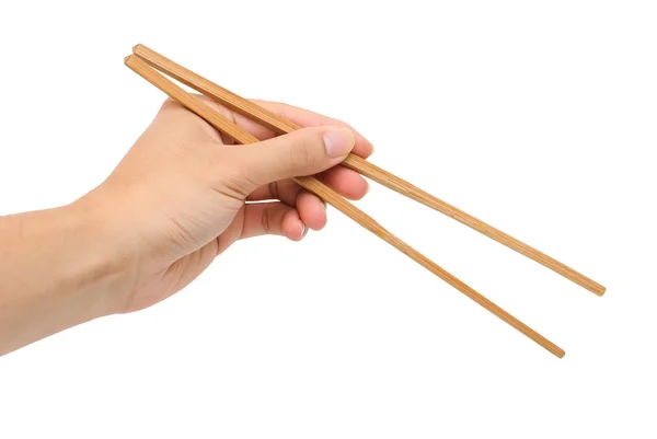 Lewa ręka osoby za pomocą bambusa pałeczki na białym tle Zdjęcia Stockowe bez tantiem
