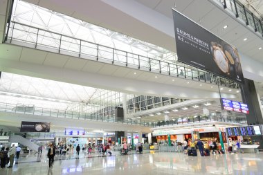 HONG KONG, CHINA - FEBRUARY 11: Passengers in the airport main lobby on February 11, 2013 in Hong Kong, China. The Hong Kong airport handles more than 70 million passengers per year.