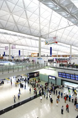 HONG KONG, CHINA - FEBRUARY 11: Passengers in the airport main lobby on February 11, 2013 in Hong Kong, China. The Hong Kong airport handles more than 70 million passengers per year.