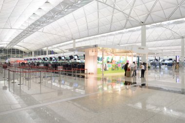 HONG KONG, CHINA - FEBRUARY 11: Passengers in the airport main lobby on February 11, 2013 in Hong Kong, China. The Hong Kong airport handles more than 70 million passengers per year.