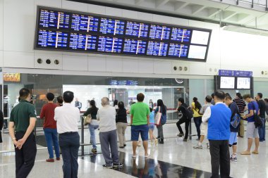 HONG KONG, CHINA - FEBRUARY 11: Passengers in the airport main lobby on February 11, 2013 in Hong Kong, China. The Hong Kong airport handles more than 70 million passengers per year.