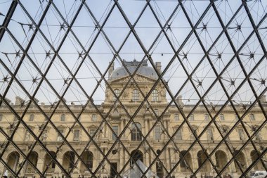 PARIS - APRIL 10: People go to famous Louvre museum on April 10, 2013 in Paris, France. Louvre is the most visited museum in the world, more 10 millions in 2012.