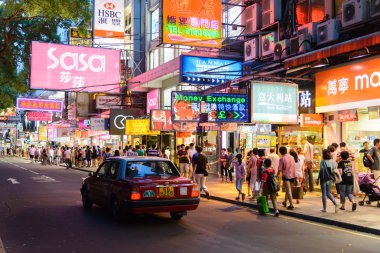 HONG KONG, CHINA - APR 23: Crowded street view at night on April 23, 2013 in Hong Kong, China. With 7M population and land mass of 1104 sq km, it is one of the most dense areas in the world.