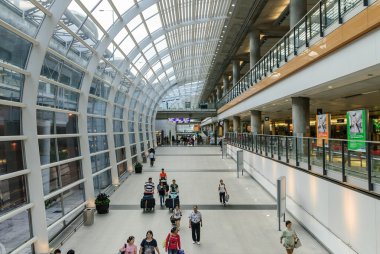 HONG KONG, CHINA - FEBRUARY 11: Passengers in the airport main lobby on February 11, 2013 in Hong Kong, China. The Hong Kong airport handles more than 70 million passengers per year.