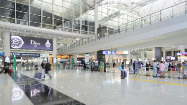 HONG KONG, CHINA - FEBRUARY 11: Passengers in the airport main lobby on February 11, 2013 in Hong Kong, China. The Hong Kong airport handles more than 70 million passengers per year.