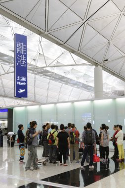 HONG KONG, CHINA - FEBRUARY 11: Passengers in the airport main lobby on February 11, 2013 in Hong Kong, China. The Hong Kong airport handles more than 70 million passengers per year.