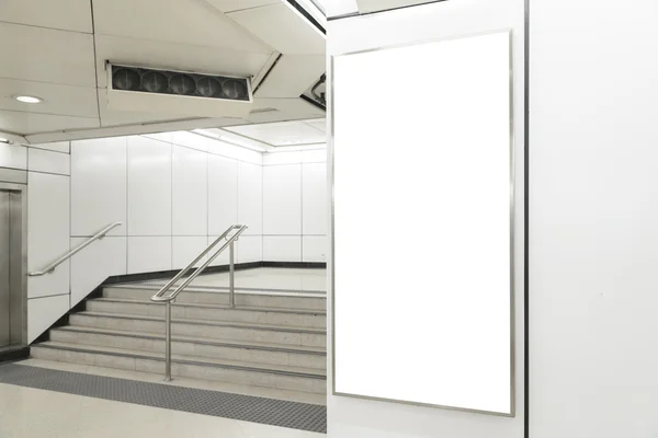 One big vertical / portrait orientation blank billboard in public transport station — Stock Photo, Image