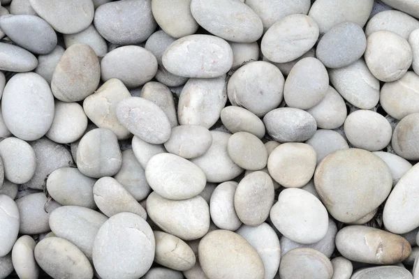 Naturally polished white rock pebbles background