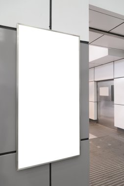 Blank big vertical / portrait orientation billboard on modern gray wall with door background