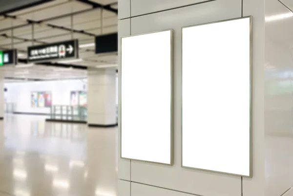 Two big vertical / portrait orientation blank billboard on modern white wall with subway concourse background — Stock Photo, Image