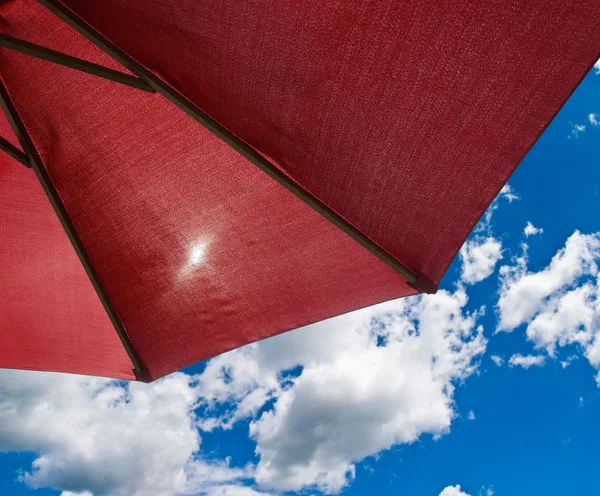 Patio umbrella against sunny blue sky