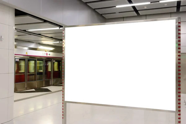 One big horizontal / landscape orientation blank billboard with train platform background