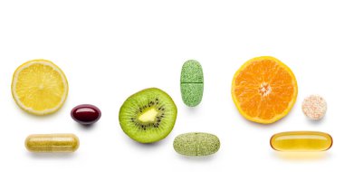 various vitamin supplement pills with citrus fruits on white background clipart