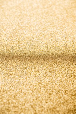 Sığ alan derinliğine sahip soyut parlak altın parıltılı arkaplan.