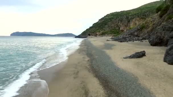 Аэросъемка пляжа со скалами на закате солнца с волнами — стоковое видео