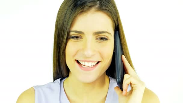 Beautiful young woman smiling and laughing talking on the phone isolated — Stock Video