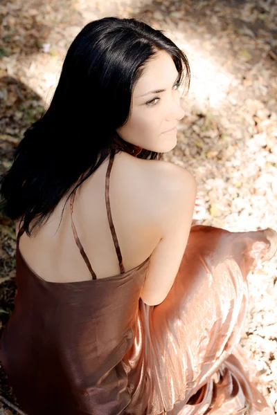 Femme pensive assise dans la forêt — Photo