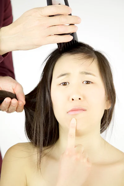 Asian woman not sure to shave her long hair — Stock Photo, Image