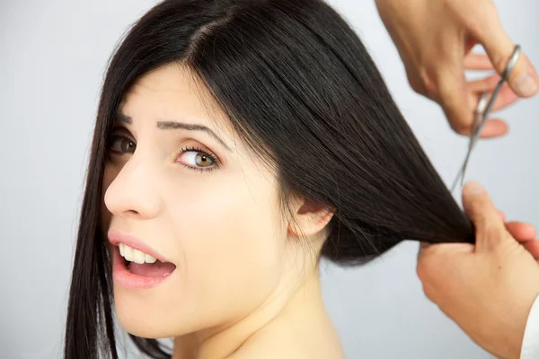 Woman surprised about getting long hair cut — Stock Photo, Image