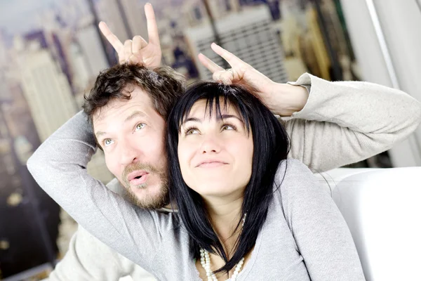 Funny couple making horns gesture one to another — Stock Photo, Image