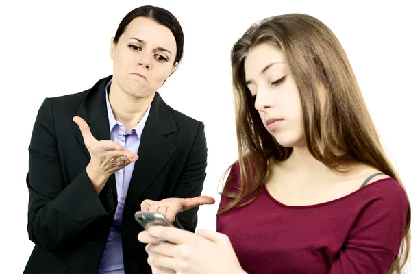 Business mother angry with daughter addicted to cell phone — Stock Photo, Image